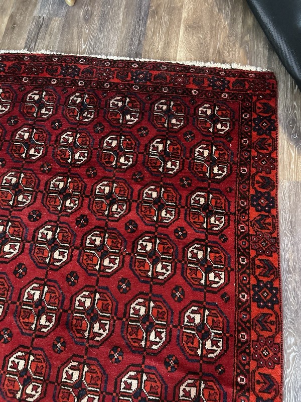 Wool hand-knotted Turkmen rug with geometric patterns in red (4' x 6') gallery