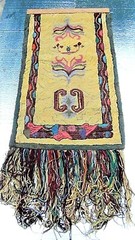 FOLK ART TEXTILE HOOKED HAND-WORK ON A BURLAP WARP W/STYLIZED FOLIATE FORM