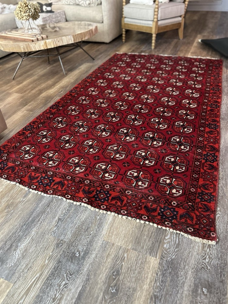 Wool hand-knotted Turkmen rug with geometric patterns in red (4' x 6')