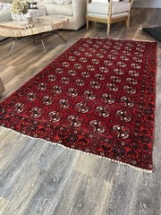 Wool hand-knotted Turkmen rug with geometric patterns in red (4′ x 6′)