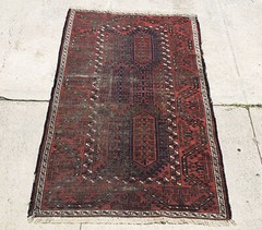 An Antique Distressed Belouch Rug